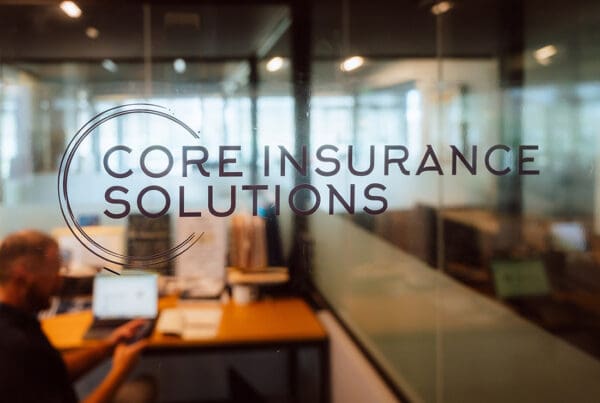 High Net Worth - Core Insurance Solutions Logo in Office Window
